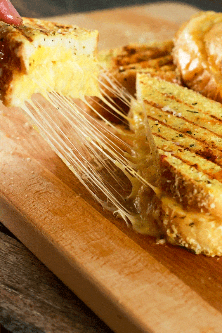 Grilled Cheese Sandwich with Garlic Parmesan Topping - This grilled cheese sandwich is going to quickly become your absolute favorite! It's SUPER easy to make and the topping stores really well! Prepare the topping ahead of time and whip this up in 5 minutes! The kids are going to LOVE this! | ScrambledChefs.com