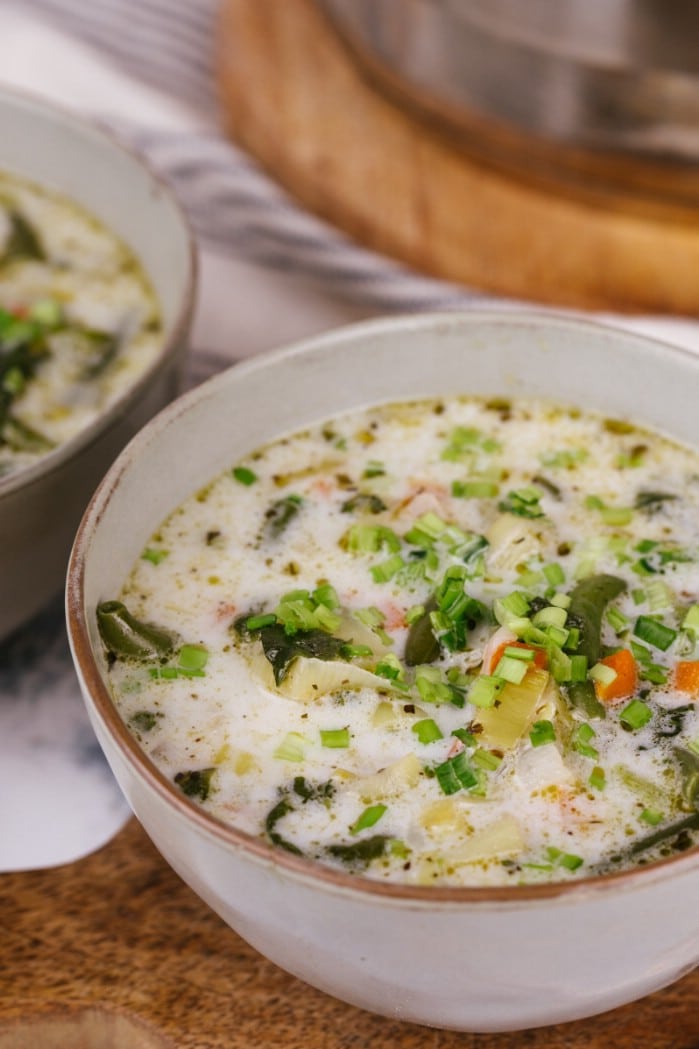 White bowl filled with creamy French onion soup