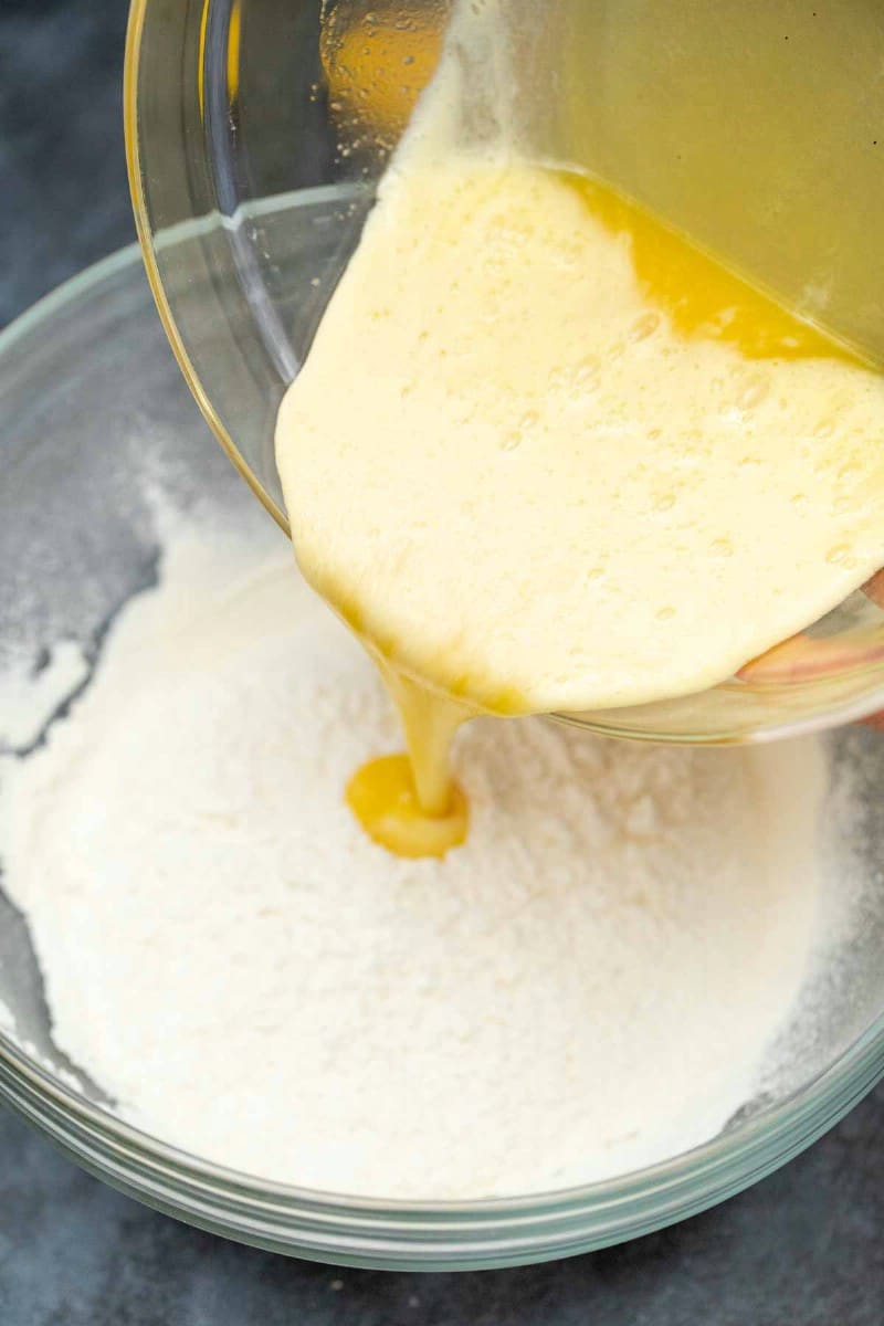 Pouring eggs into dry mix