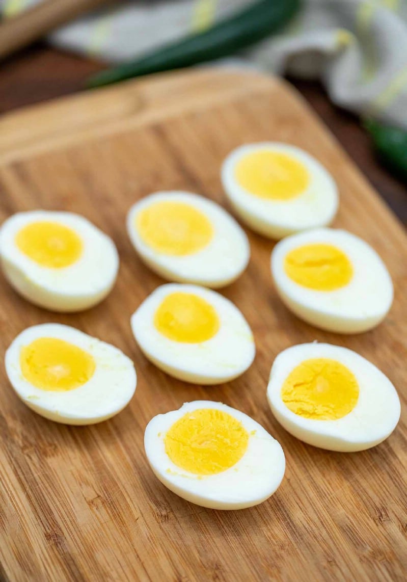 Sliced hard boiled eggs on cutting board
