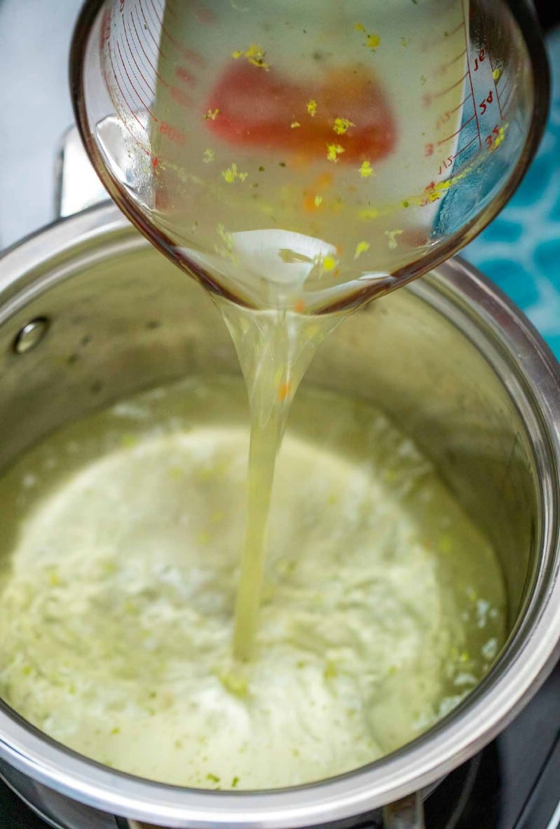 Adding broth to stockpot