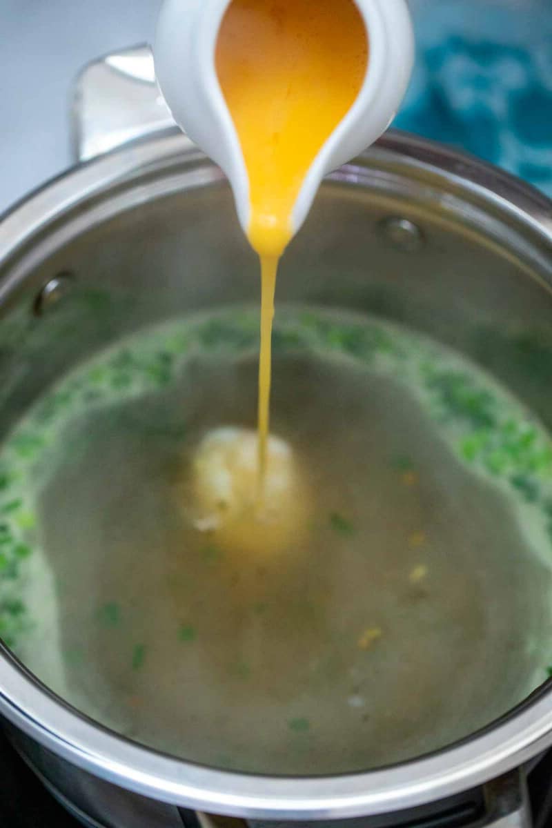 Pouring eggs into a stockpot