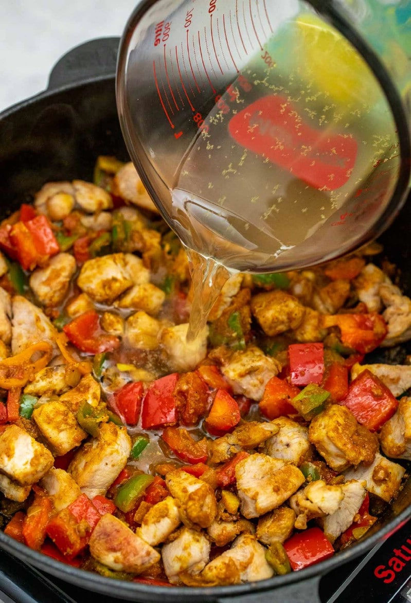 Adding chicken broth to skillet
