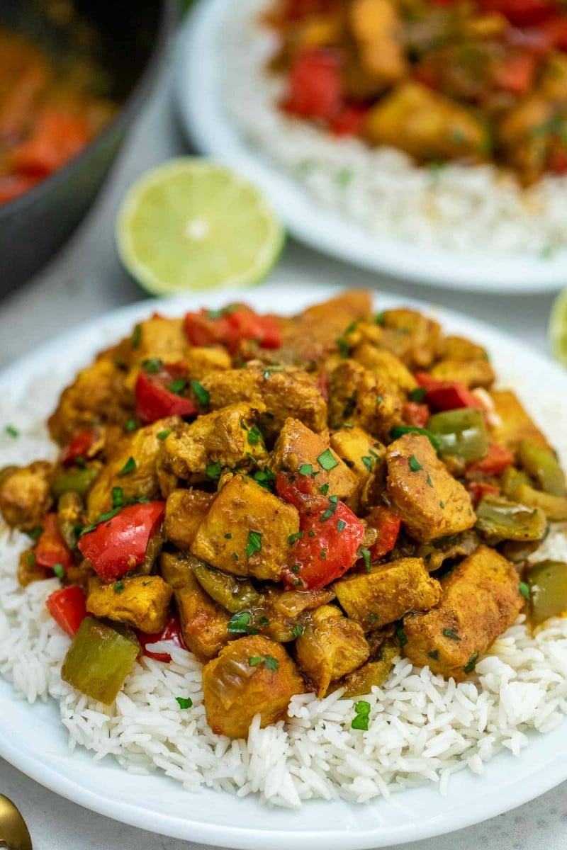 Jamaican chicken curry on white plate with rice
