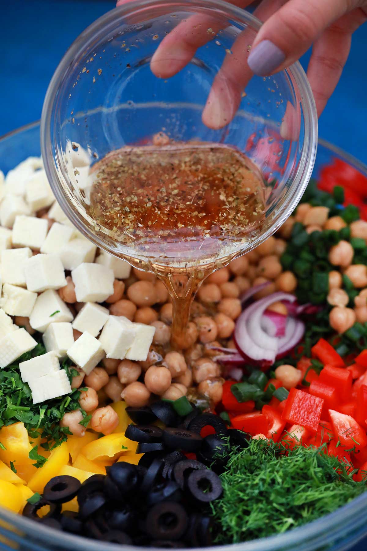 Adding dressing over vegetables