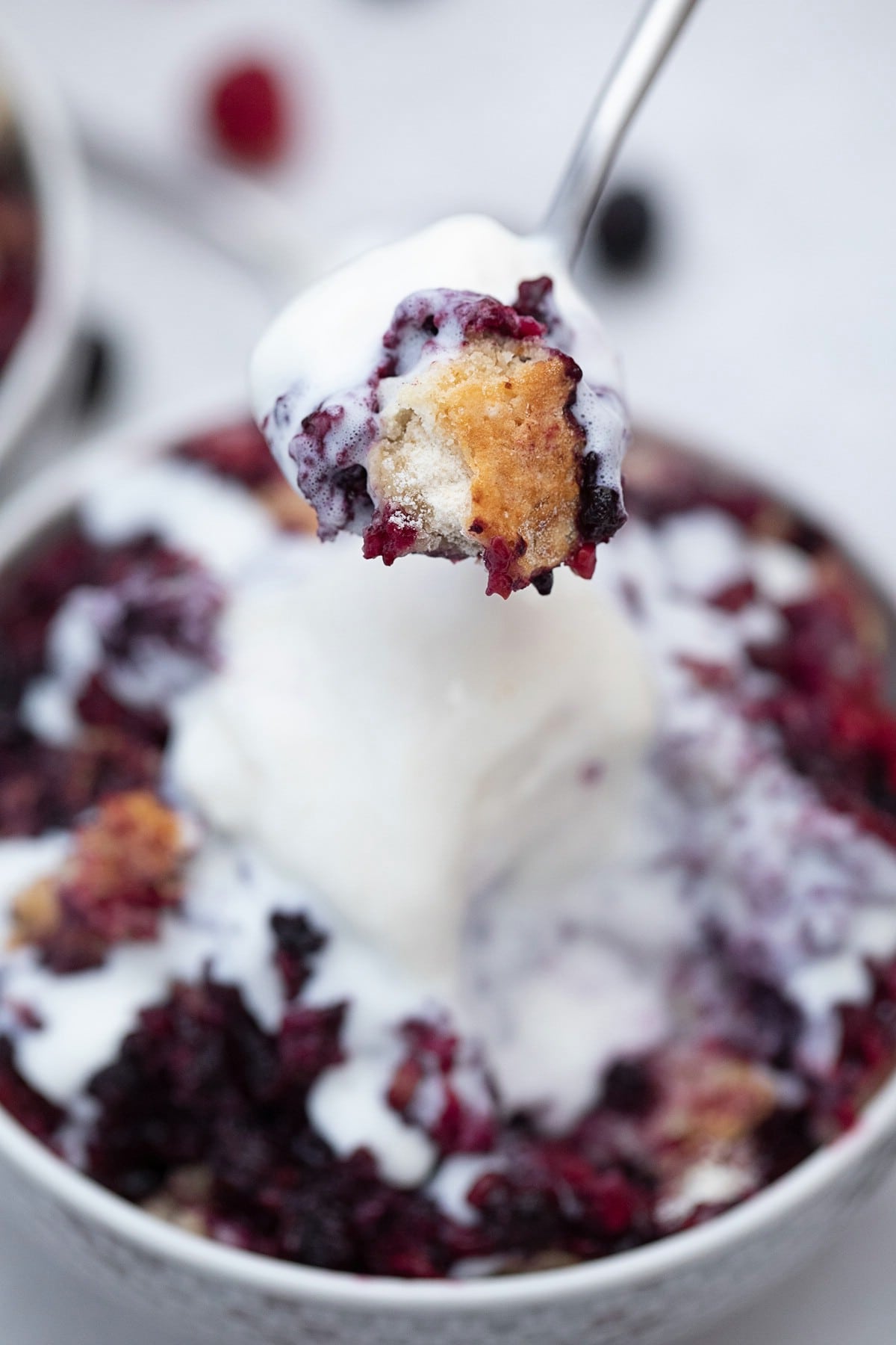 Spoon of cobbler and ice cream