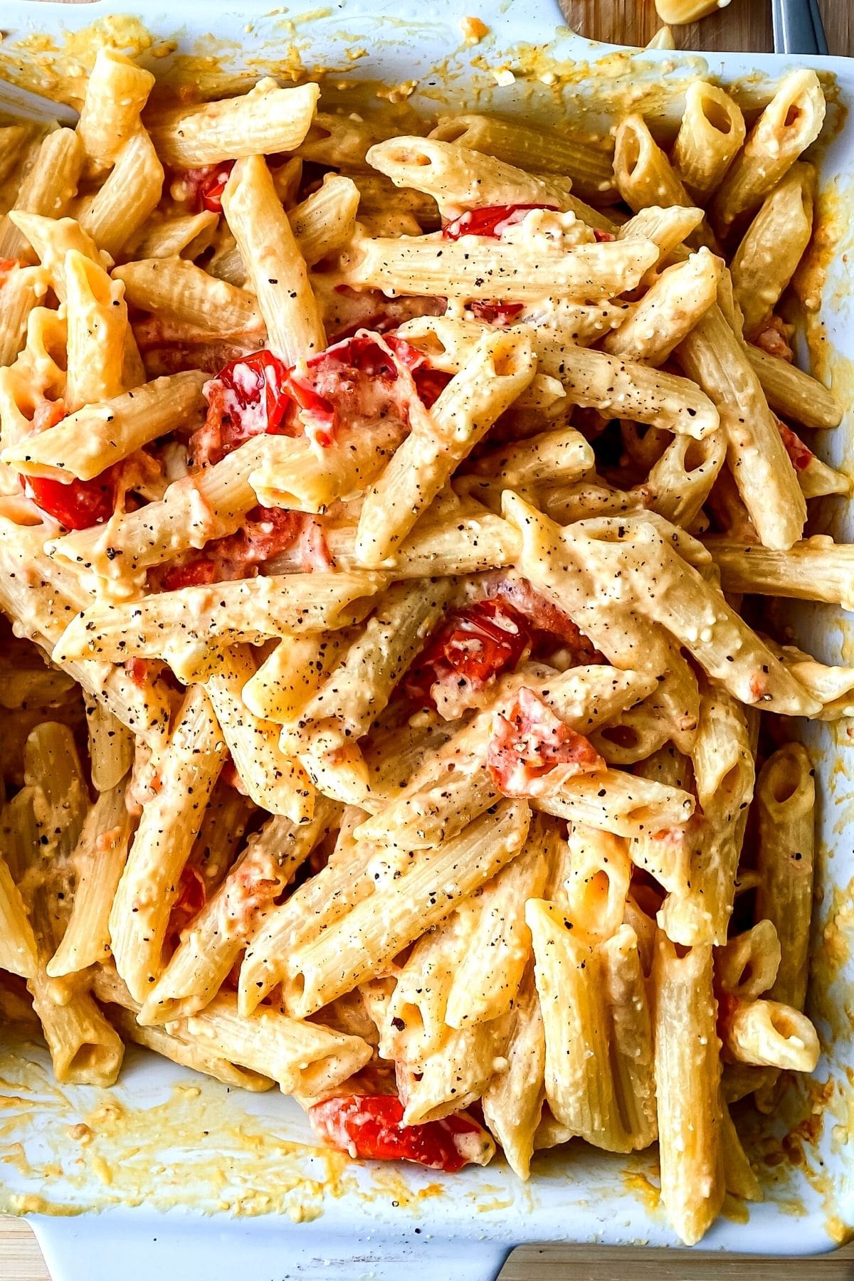 Dish of baked pasta on cutting board