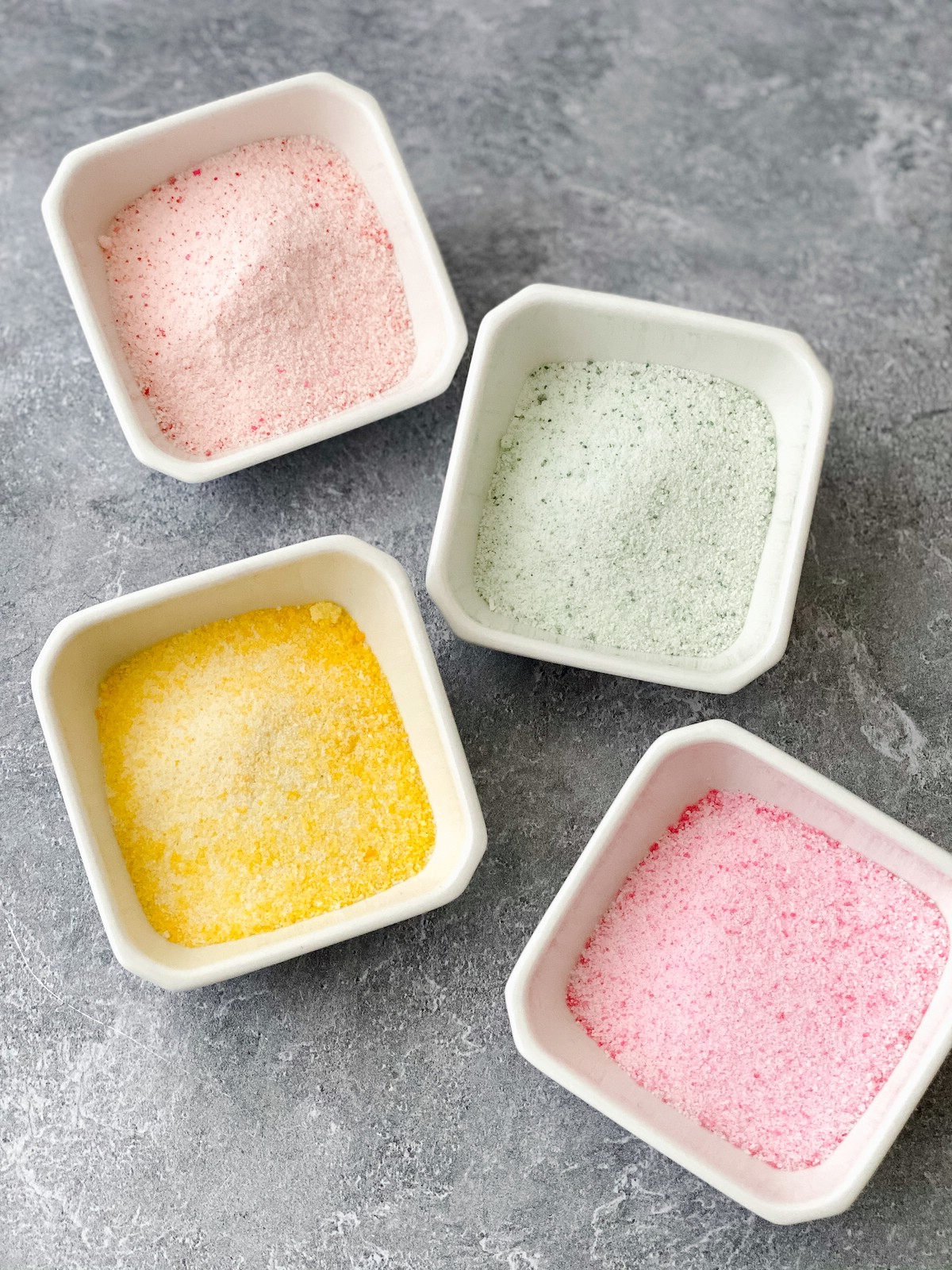 White bowls of pastel sugar