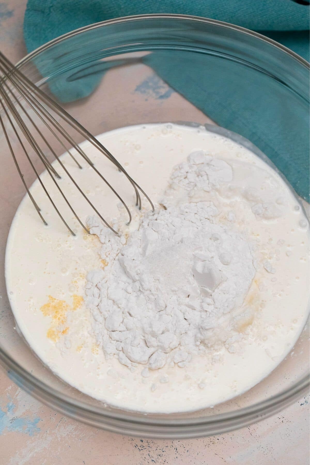 Whisking ingredients in large glass bowl