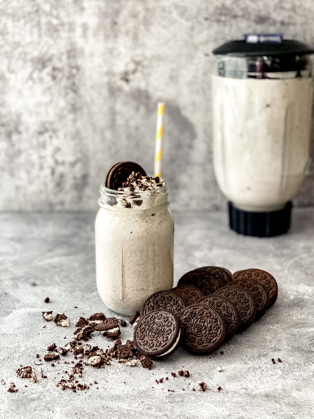 OREO Mcflurry in mason jar with blender in background and oreo in foreground