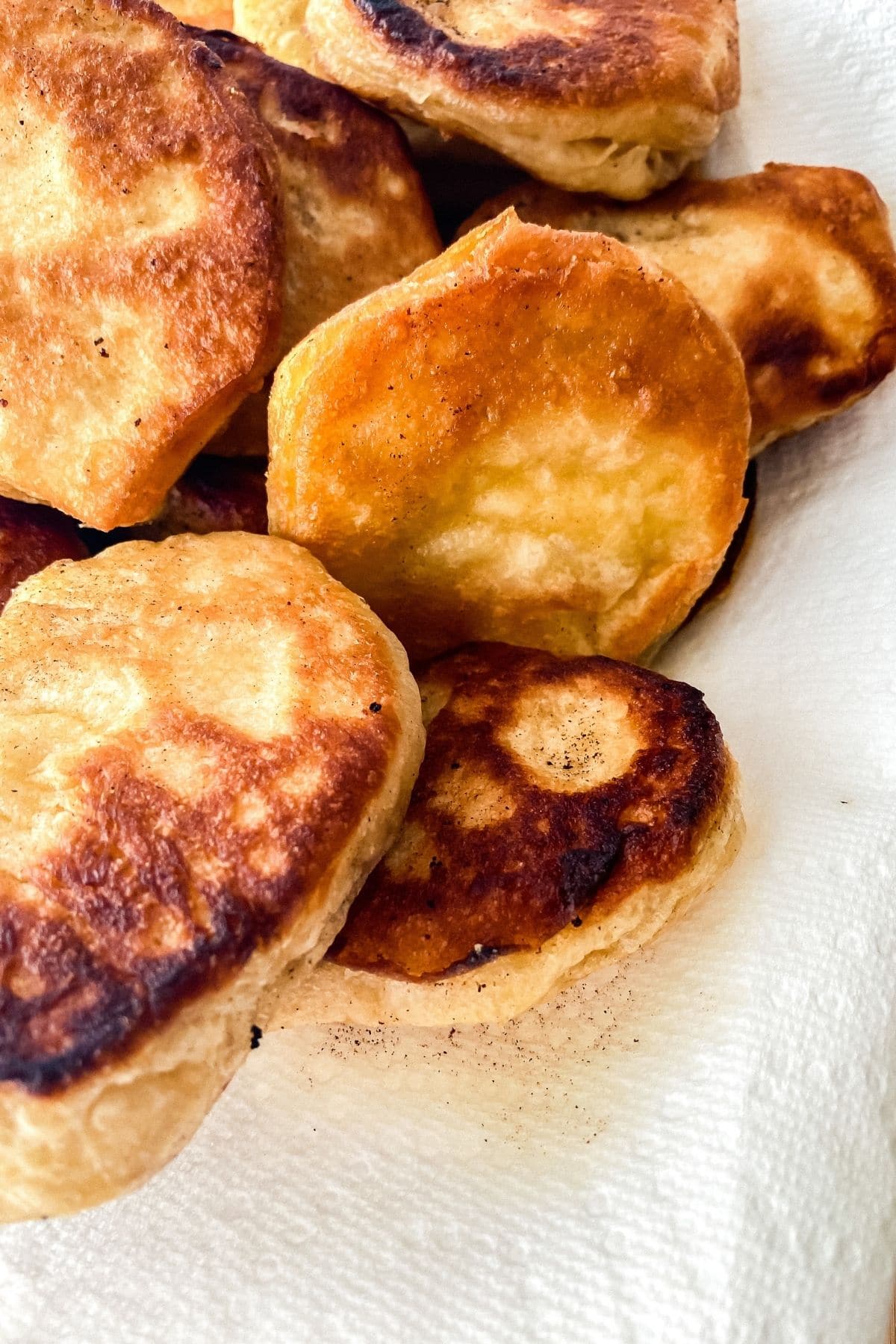 Fried biscuits on paper towels