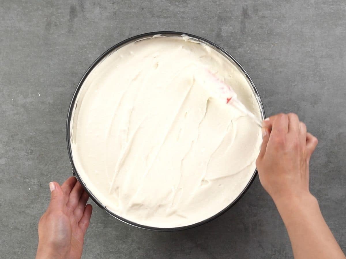 Spreading filling over the top of cracker crust in springform pan