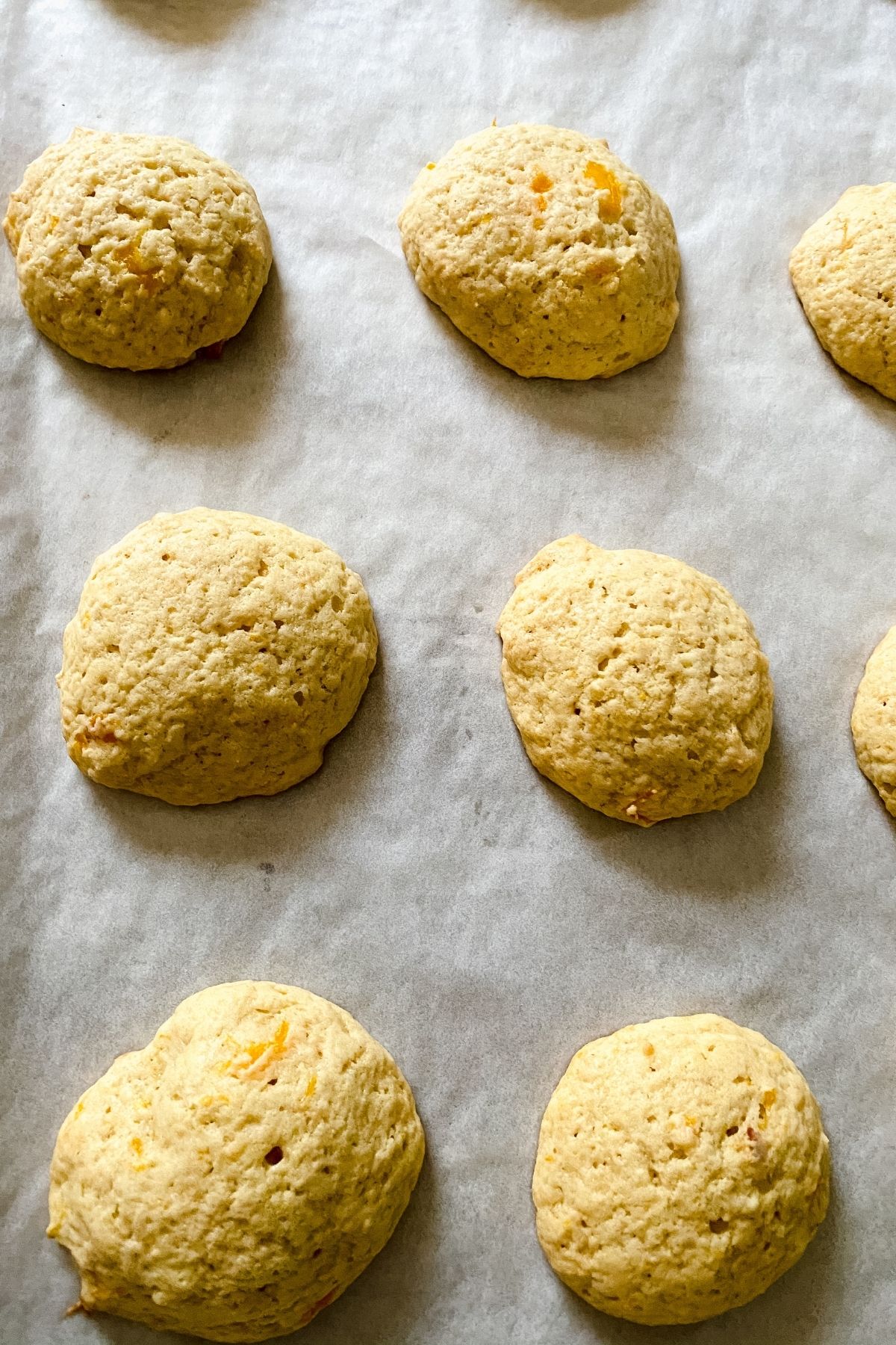 Light brown cookies on parchment lined baking sheet