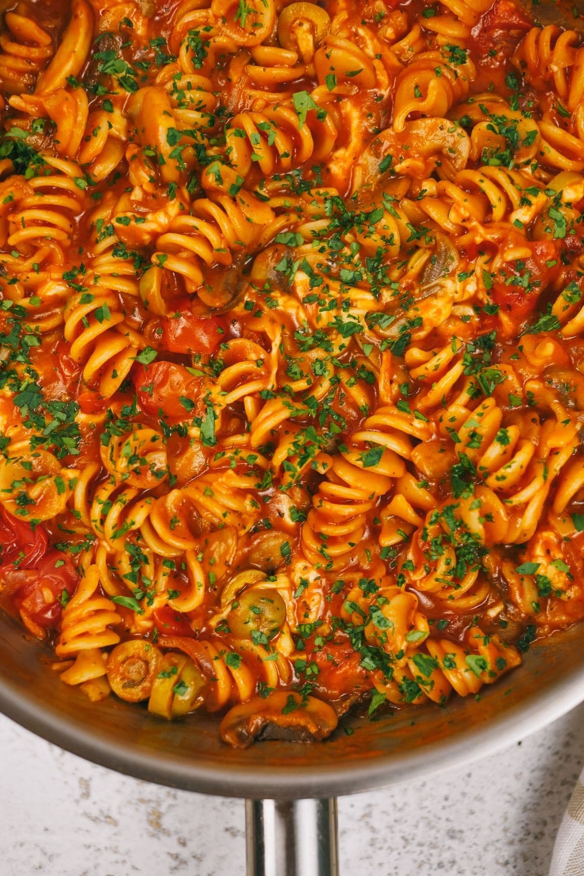 Skillet filled with pasta in tomato sauce