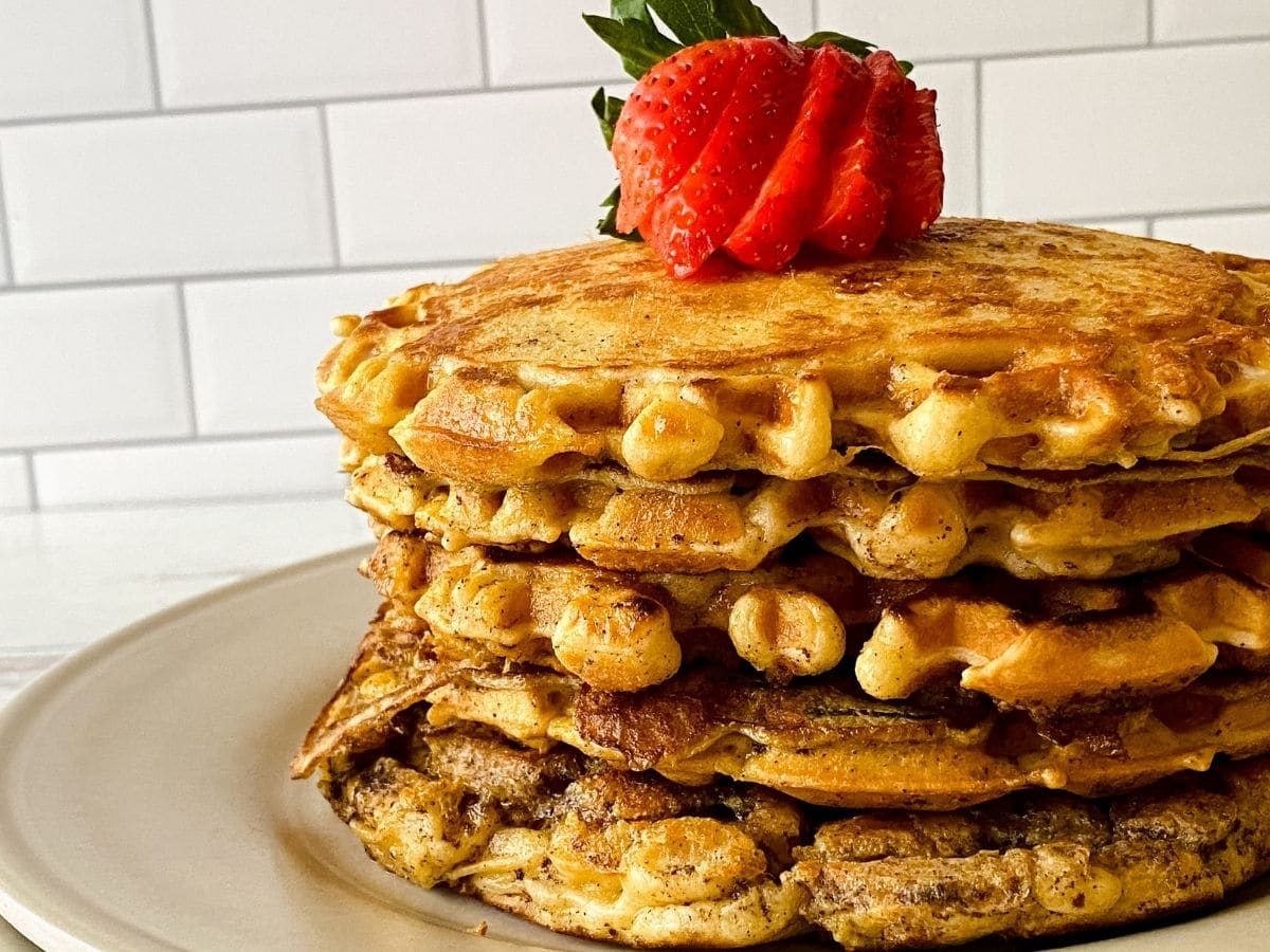 stack of pawaffles on cream plate with strawberry on top