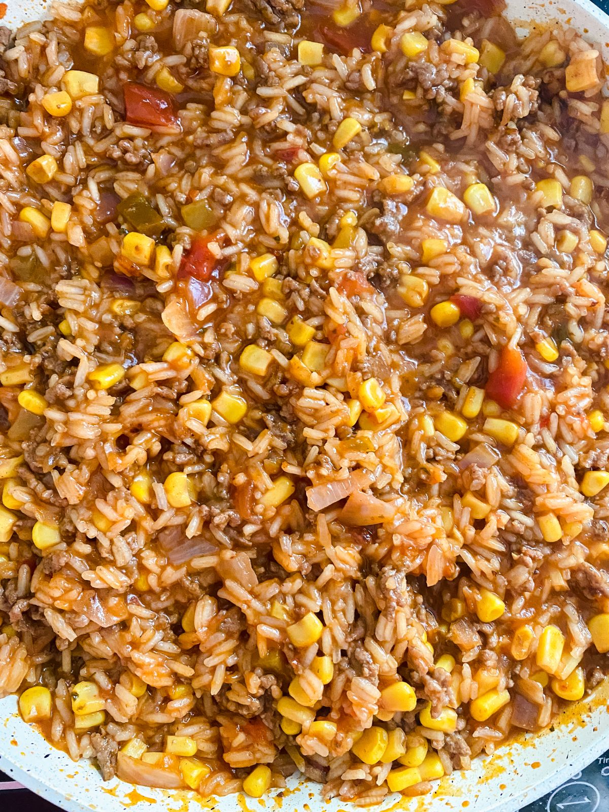 rice beef corn and sauce mixed together in skillet