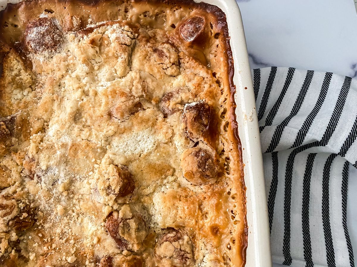 cream baking dish of bread pudding on top of striped napkin