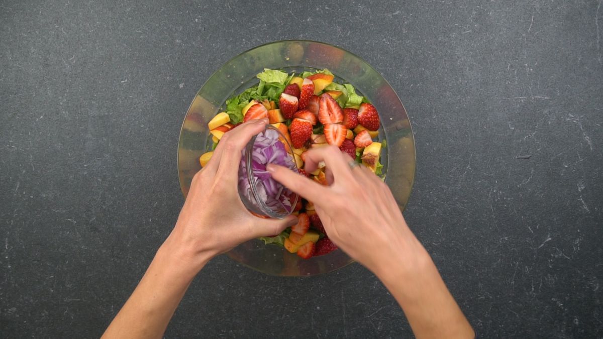 onions being added to salad