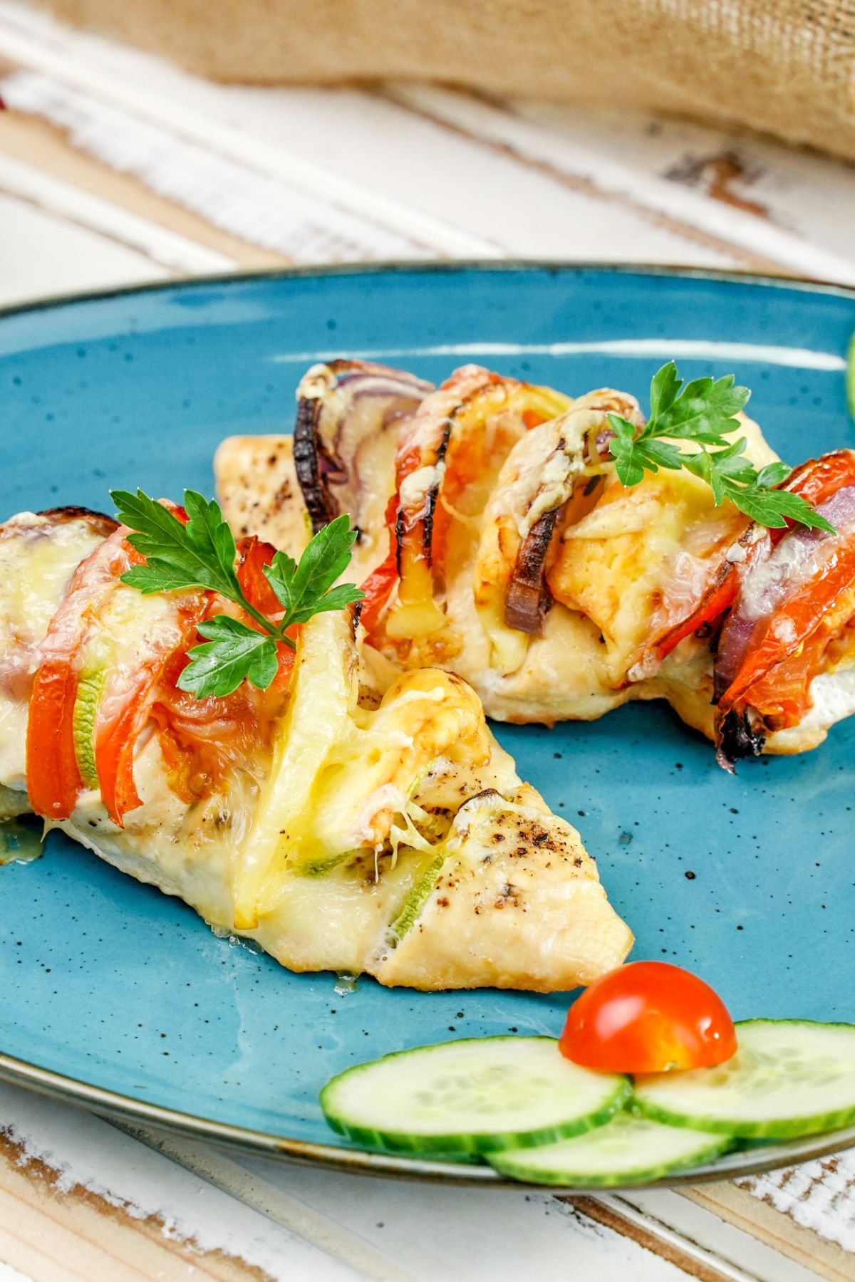 two stuffed chicken breasts on blue plate