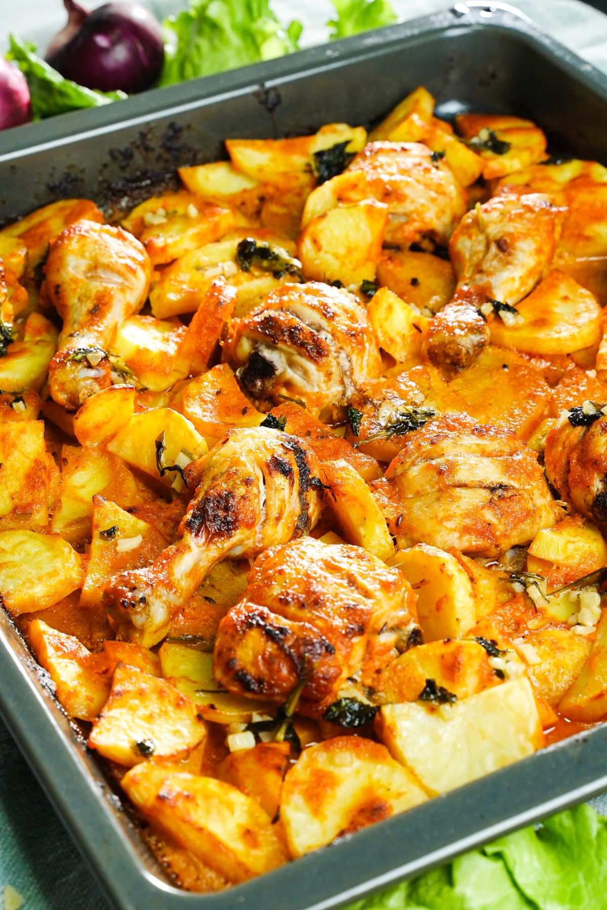metal pan holding potatoes and chicken