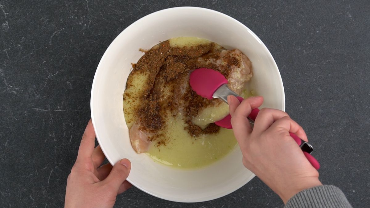 coating chicken in marinade
