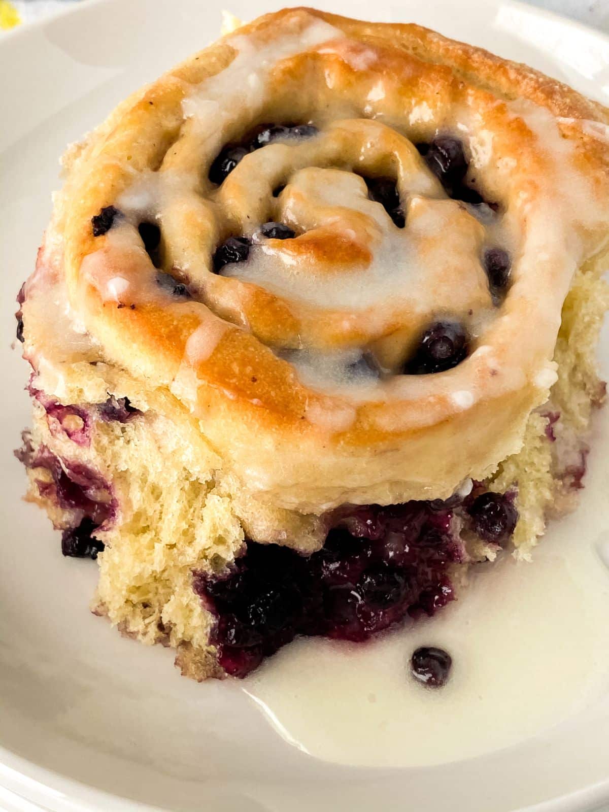 glazed blueberry lemon roll on plate