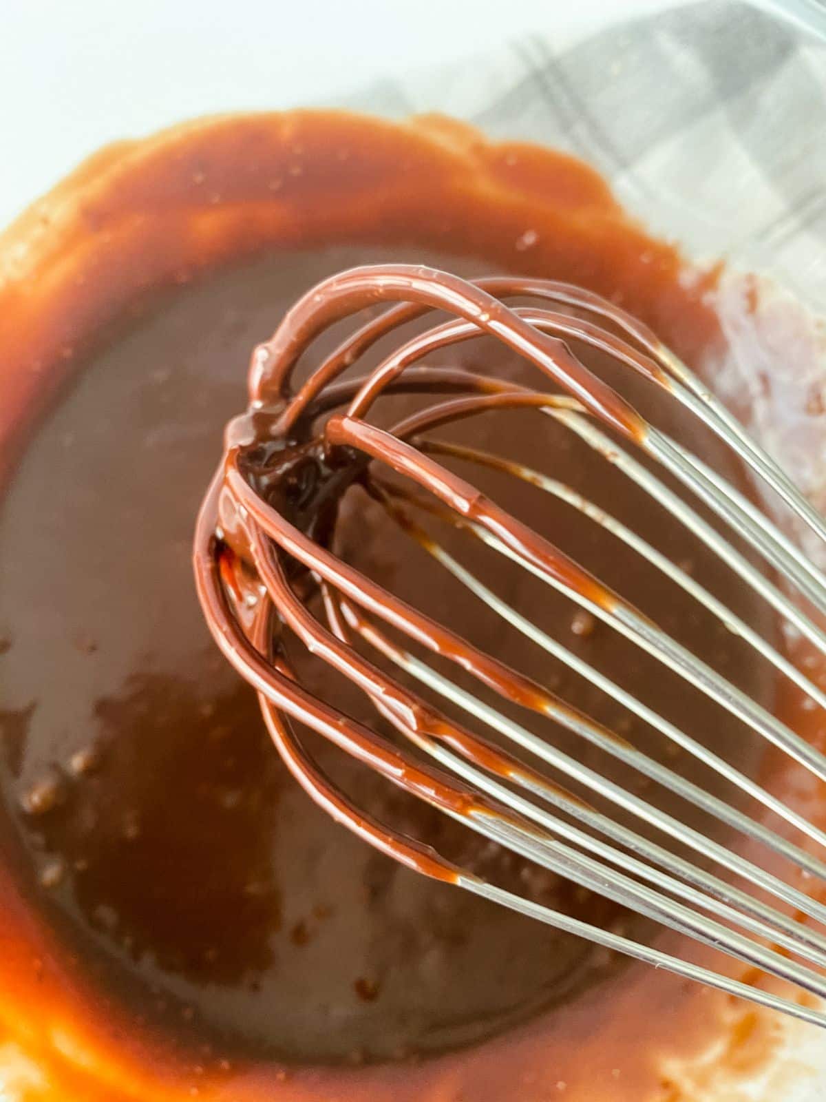whisk in bowl of ganache