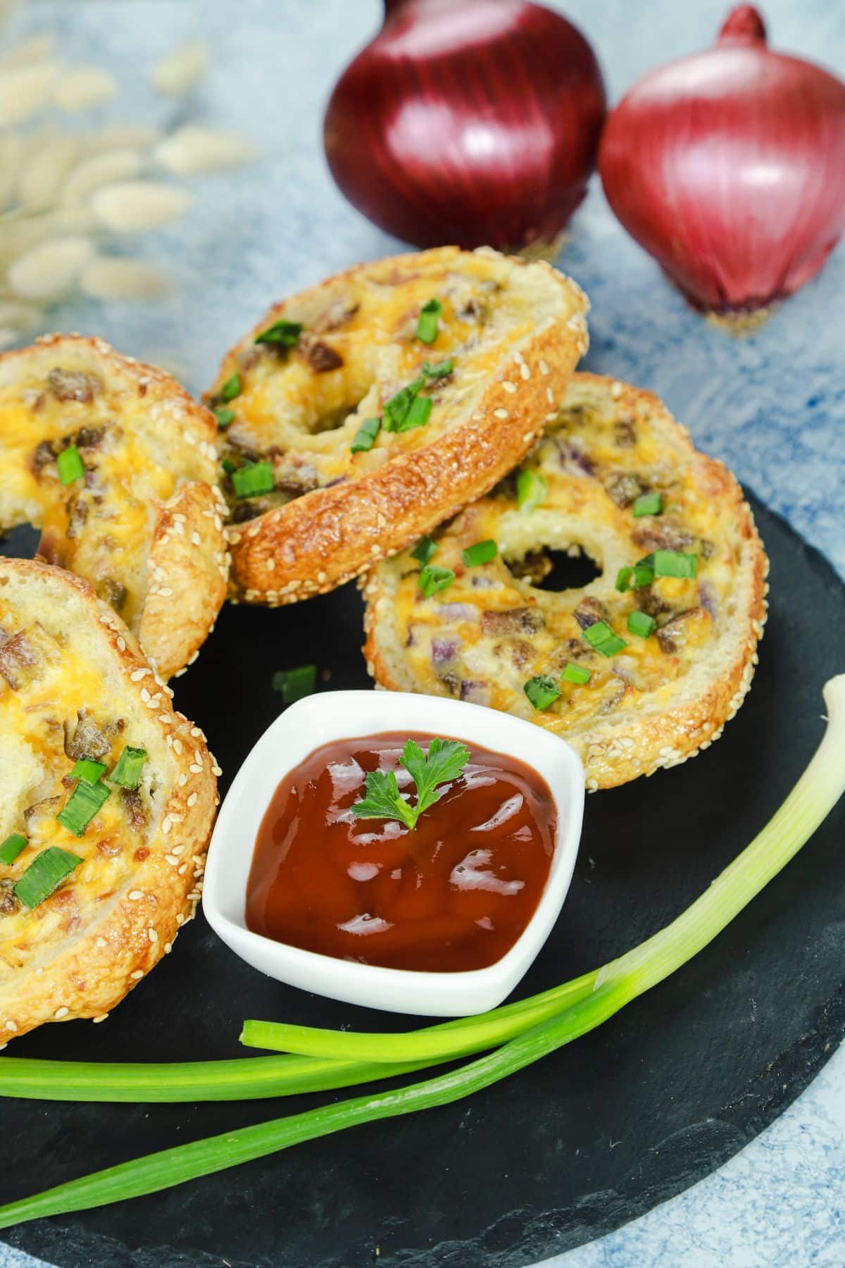 bowl of ketchup on plate by stuffed bagel