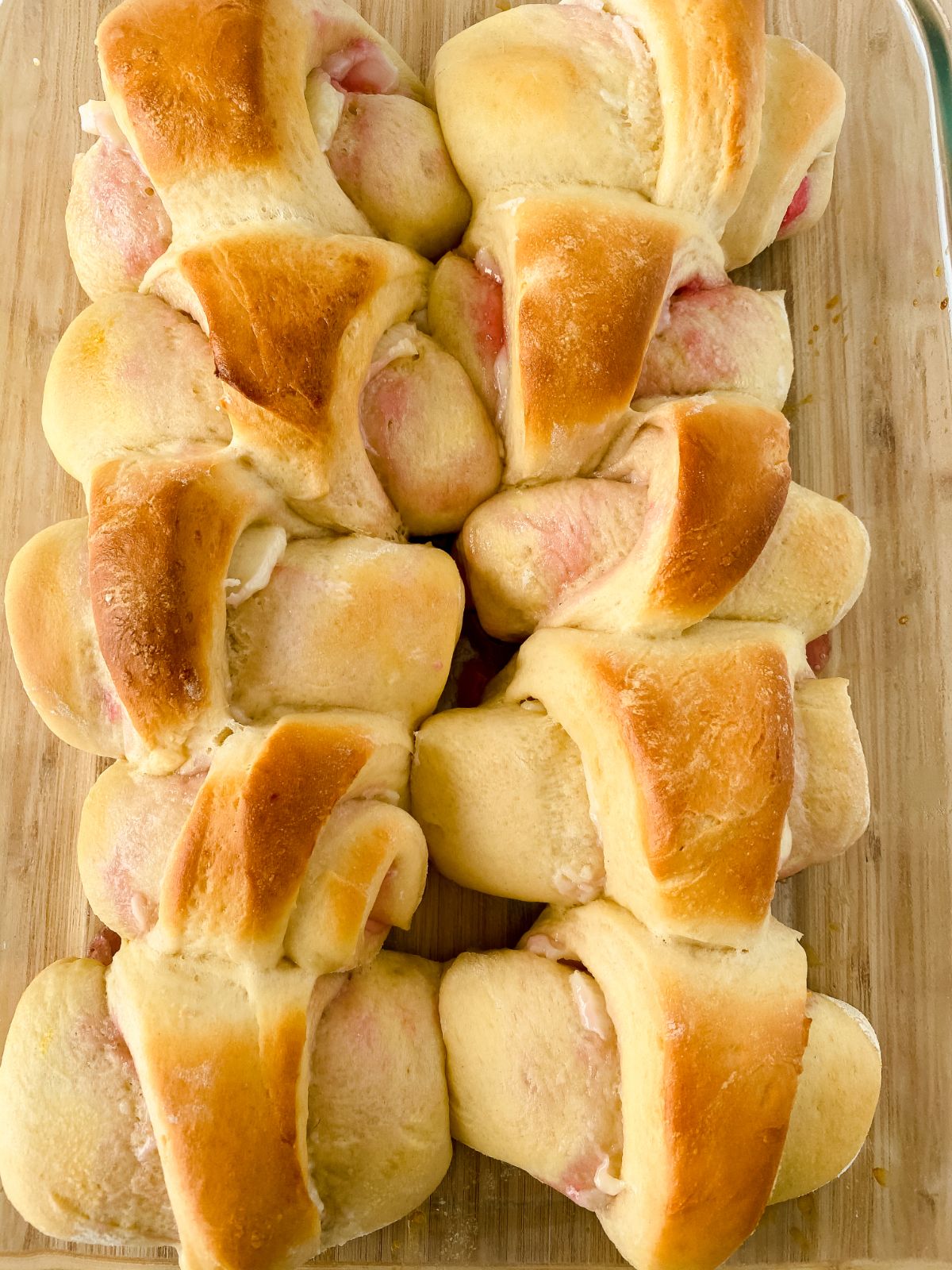 cooked raspberry cheesecake rolls on cutting board