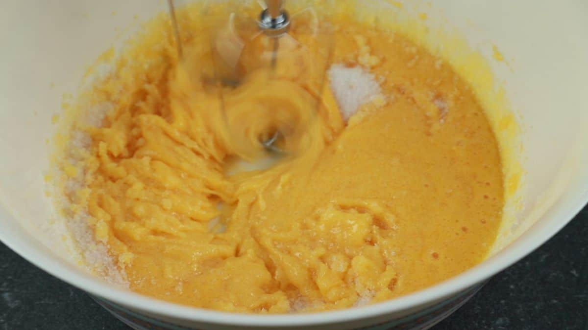eggs and sugar being mixed in bowl