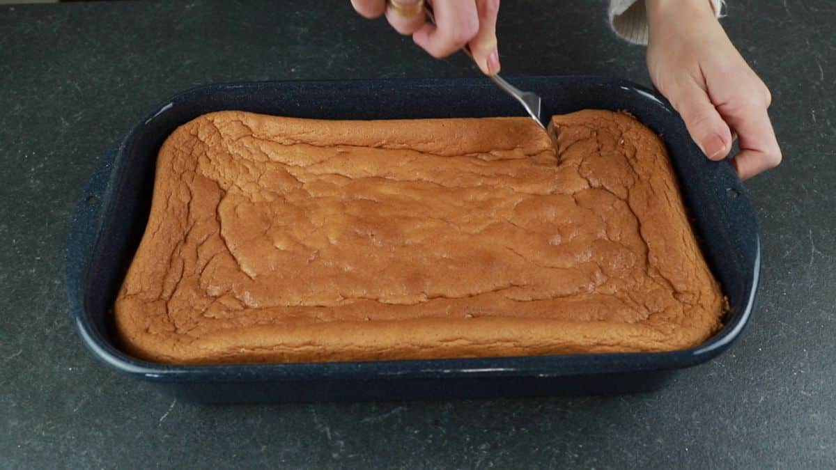 fork making holes in top of cake